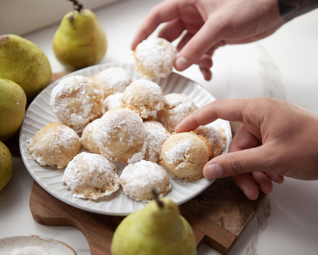 Hands Grabbing Almond Vanilla Protein Cookies with Pears