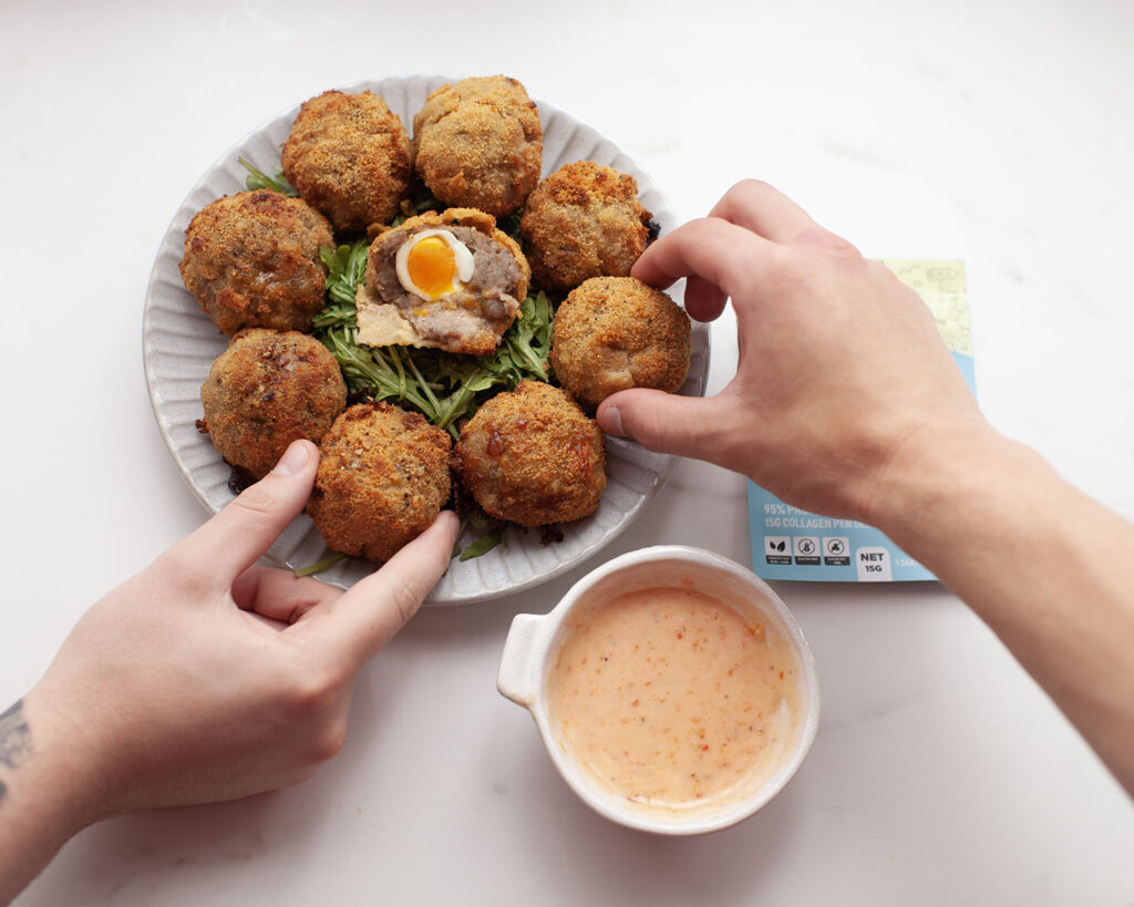 Hands Grabbing Quail Scotch Eggs