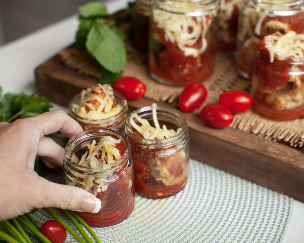 Hand grabbing Chicken Meatball Mozza Pot