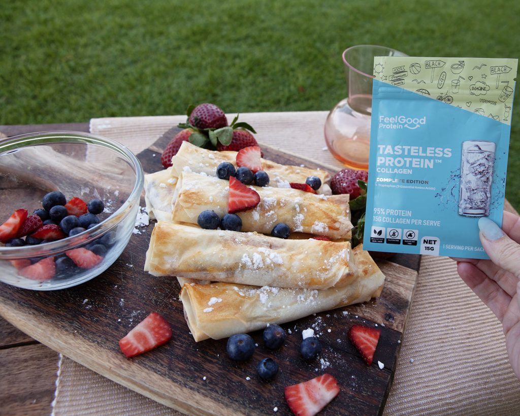 Hand Holding Tasteless Protein with Berry Cheesecake Spring Rolls