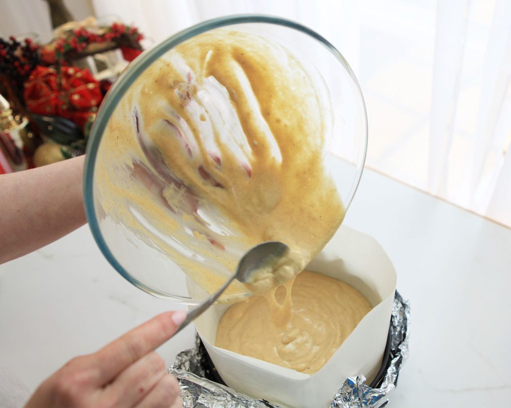 Low Carb Eggnog Cheesecake Recipe - Pouring wet ingredients into pan