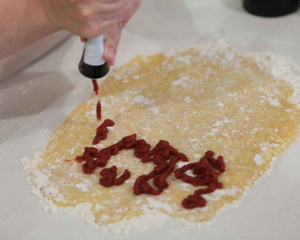 Adding tomato & basil paste