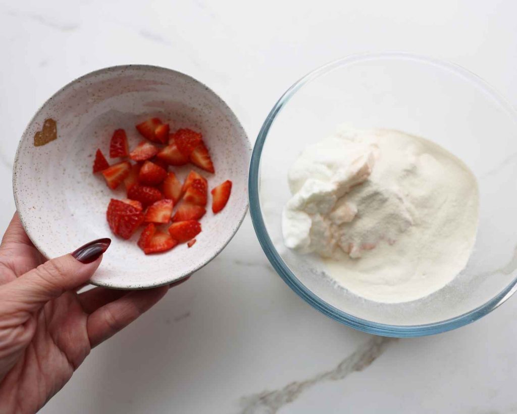adding strawberries to yoghurt 