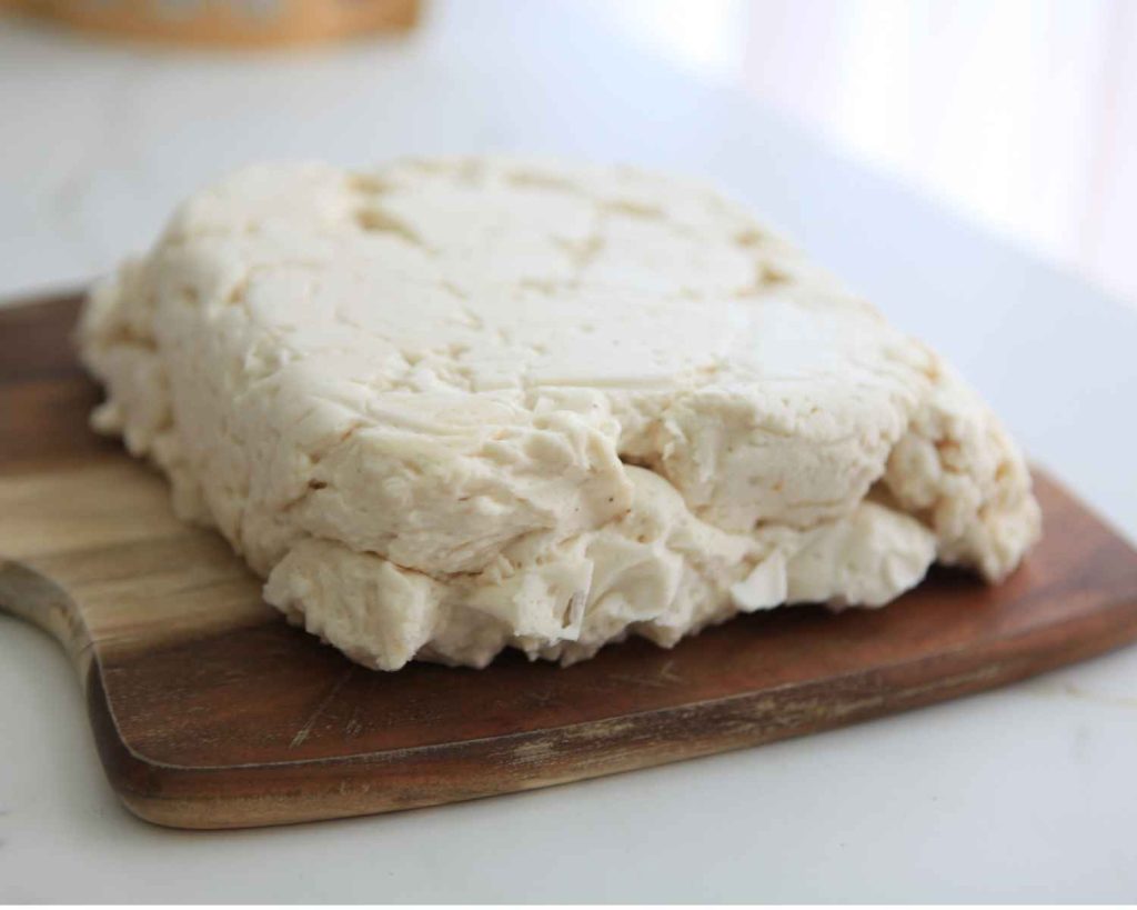cutting the vanilla protein marshmallow recipe into squares to serve 
