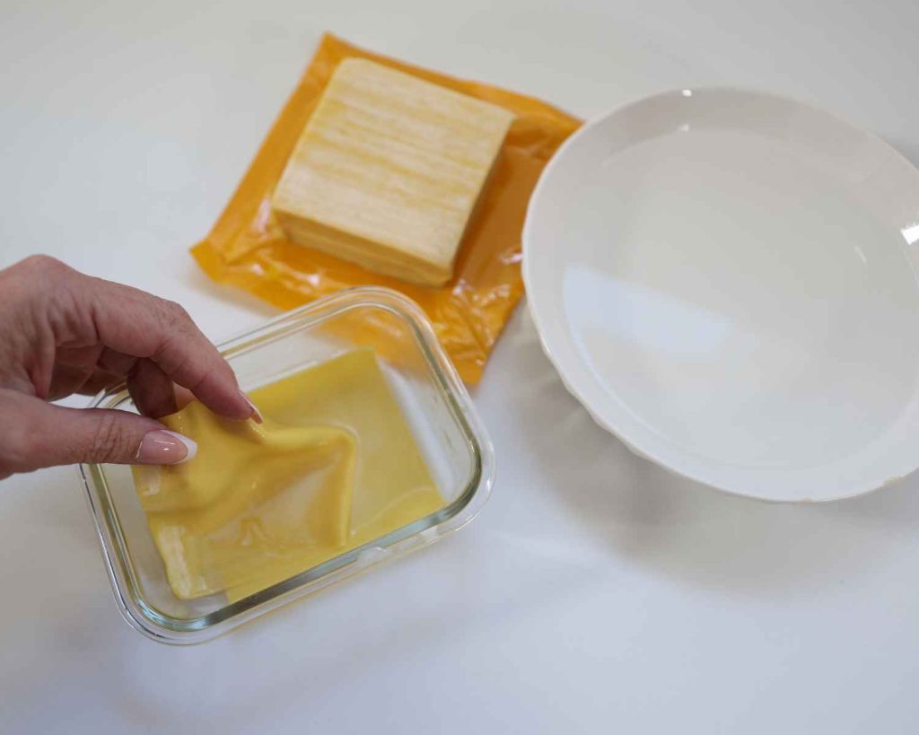 wetting the dumpling wrappers before building the dumpling bake