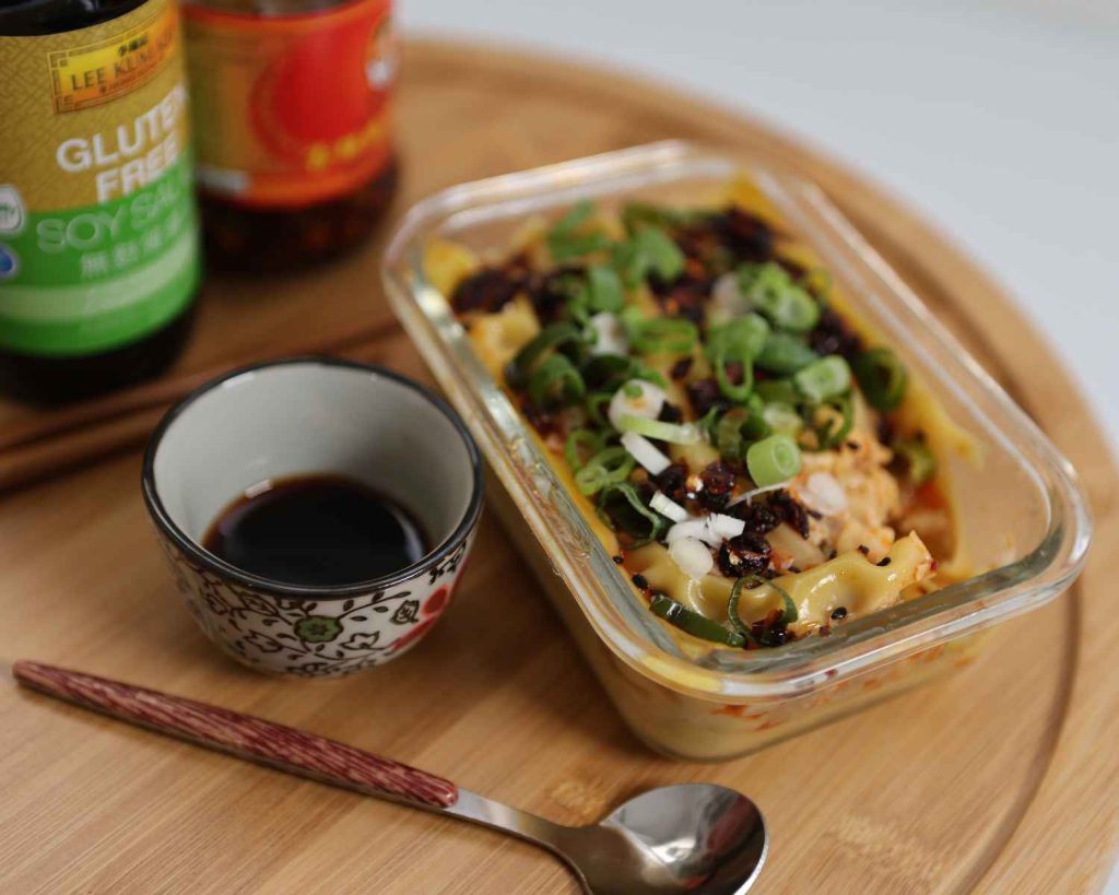 Adding the toppings to the cooked Viral Dumpling Bake