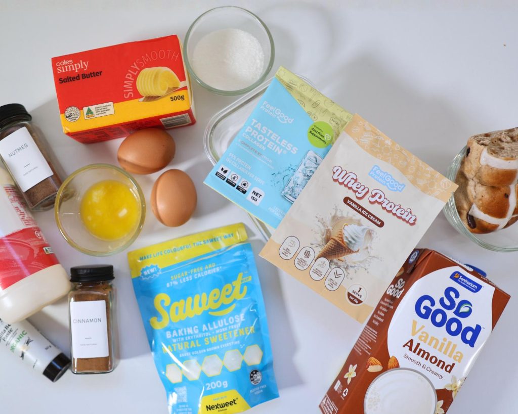 Overhead shot of Hot Cross Bun Custard Pudding ingredients spread out side by side on a white benchtop.
