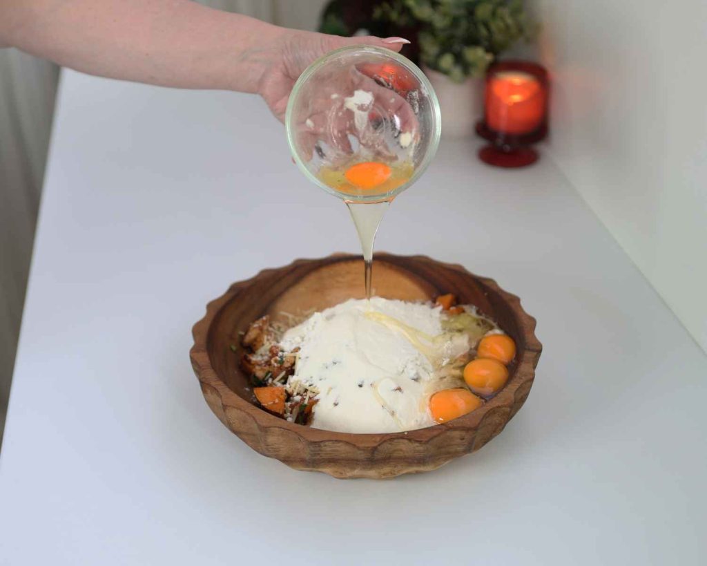 An image of the eggs being added to the mixture for the BBQ Chicken & Sweet Potato Muffins recipe