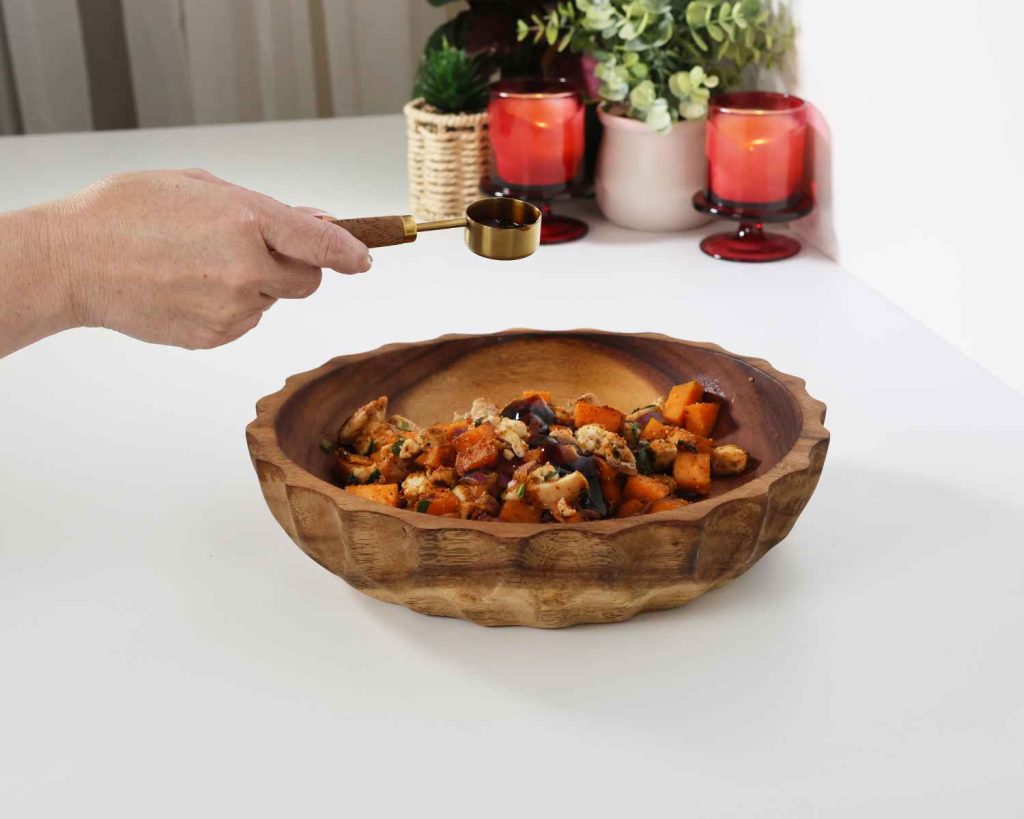 An image of oyster sauce being added to the mixture for the BBQ Chicken & Sweet Potato Muffins recipe