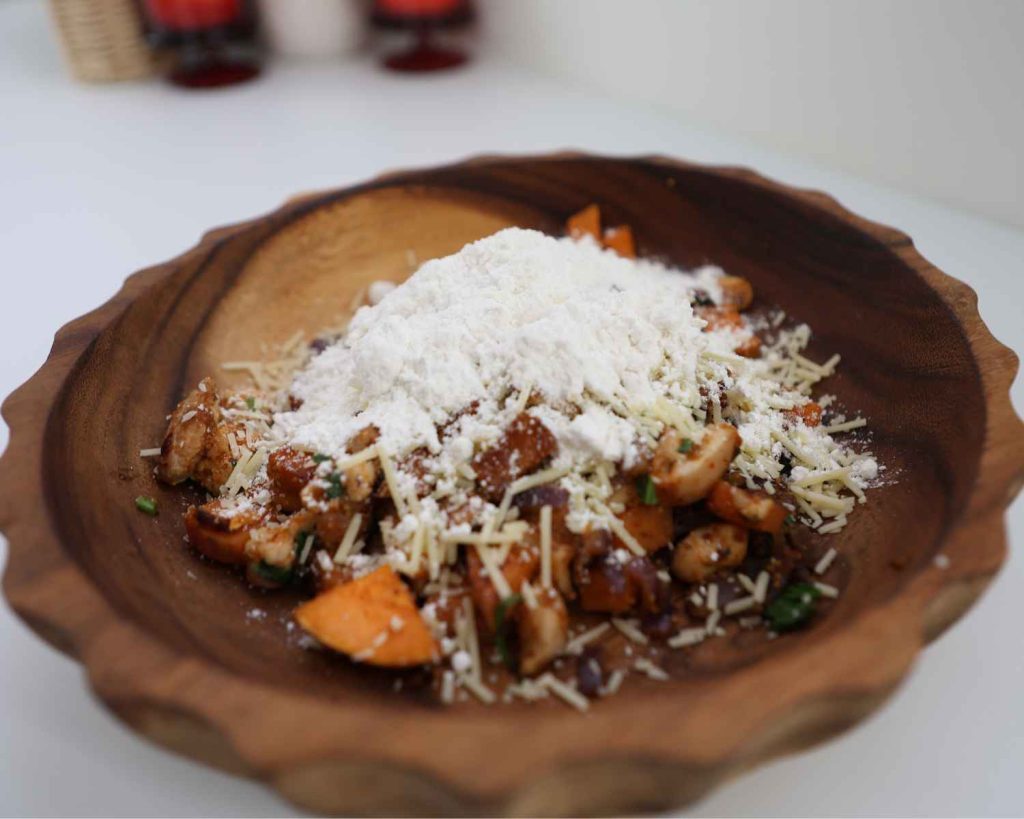An image of Parmesan cheese being added to the mixture for the An image of oyster sauce being added to the mixture for the BBQ Chicken & Sweet Potato Muffins recipe recipe