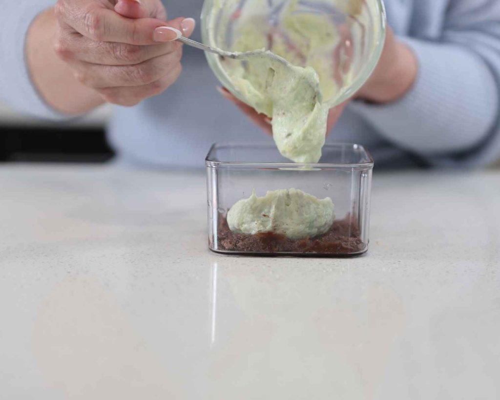 Adding the yoghurt mixture over the base for the St Patrick’s Day Protein Cheesecake recipe