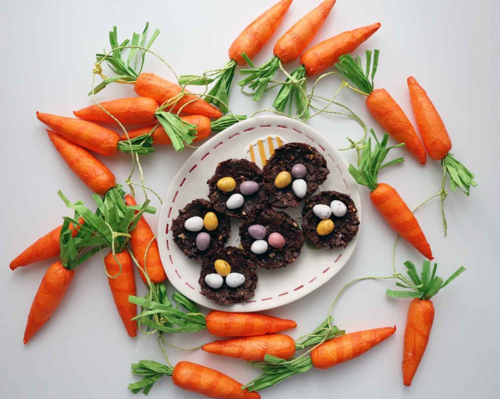 Chocolate Protein Easter Nests surrounded by easter carrots