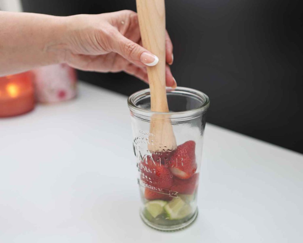 Muddle together lime and strawberries