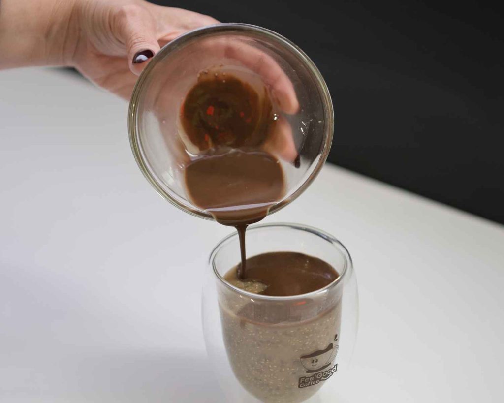Adding melted chocolate to the top of the chia seed pudding