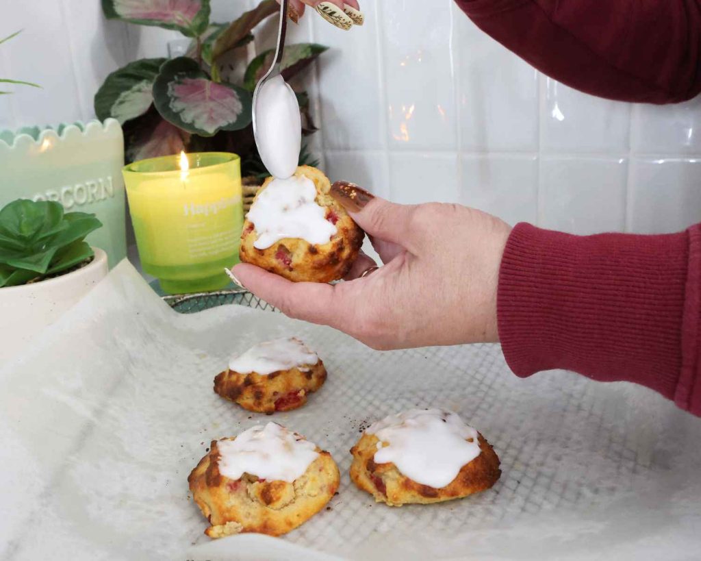 Adding the icing topping to the cooled cookies