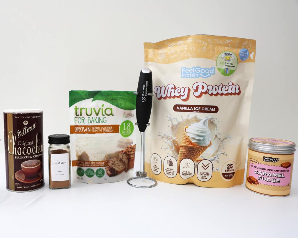 Front-facing photo showing all the ingredients for Caramel Brown Sugar Shaken Espresso arranged side by side on a benchtop, with a softly blurred modern kitchen in the background. 