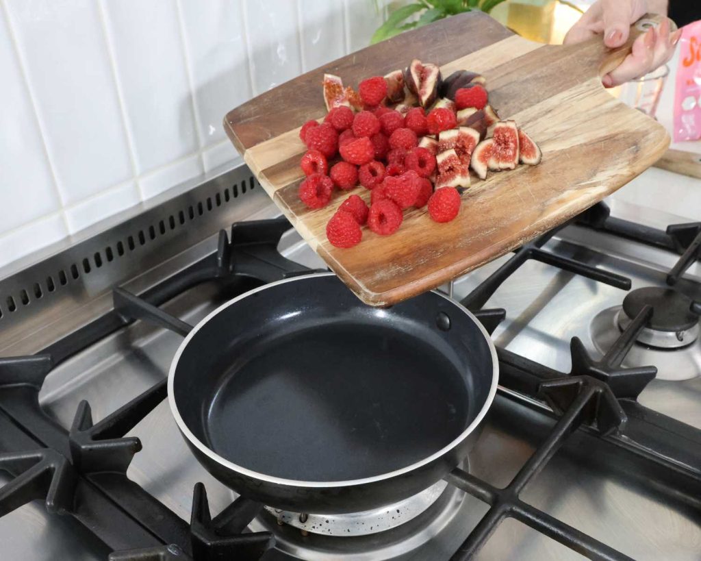 Adding raspberries and figs to a pan