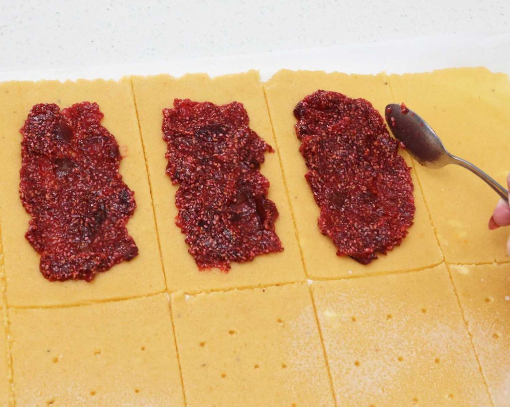 Adding the fig and raspberry jam into the centre of the pastry
