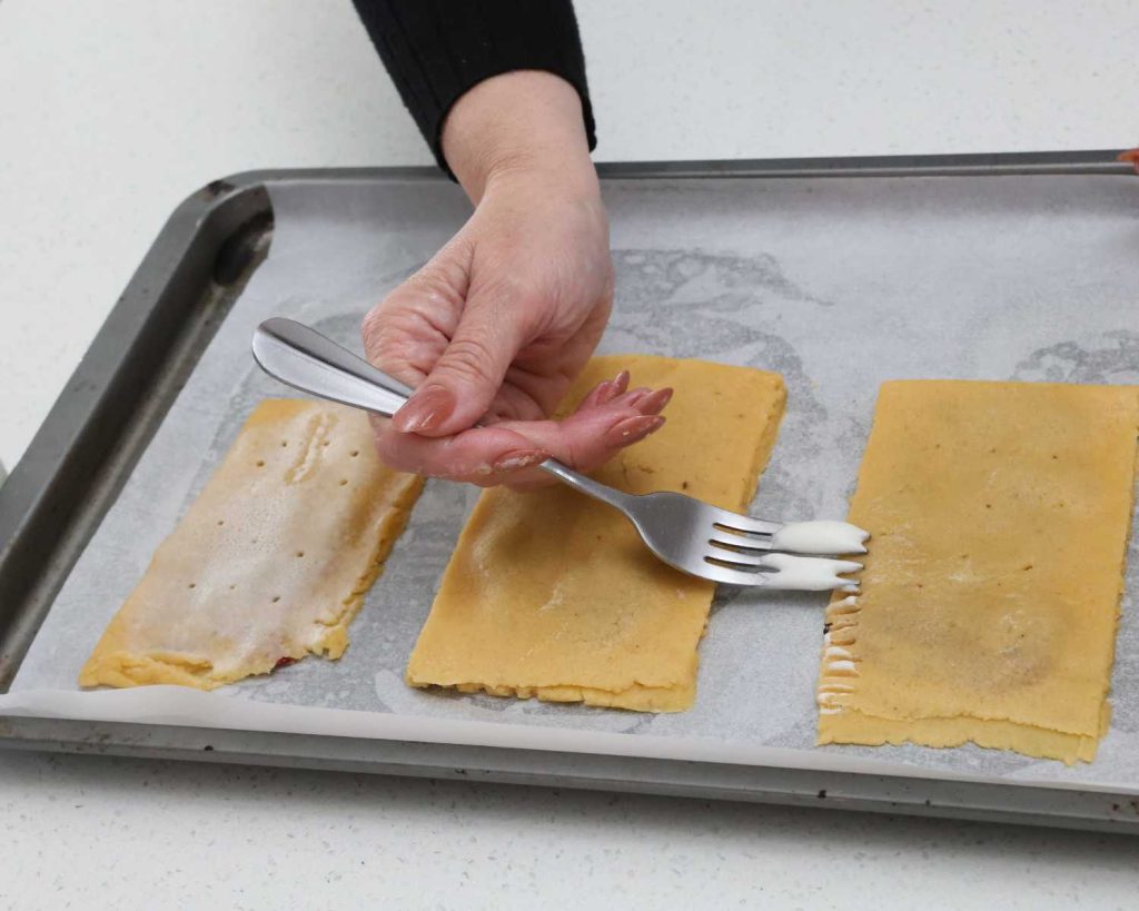 Folded pop tarts being secured round the edges