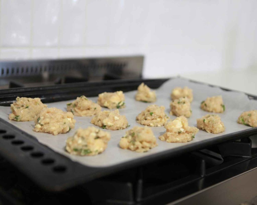 Chicken bites on a baking tray before cooking