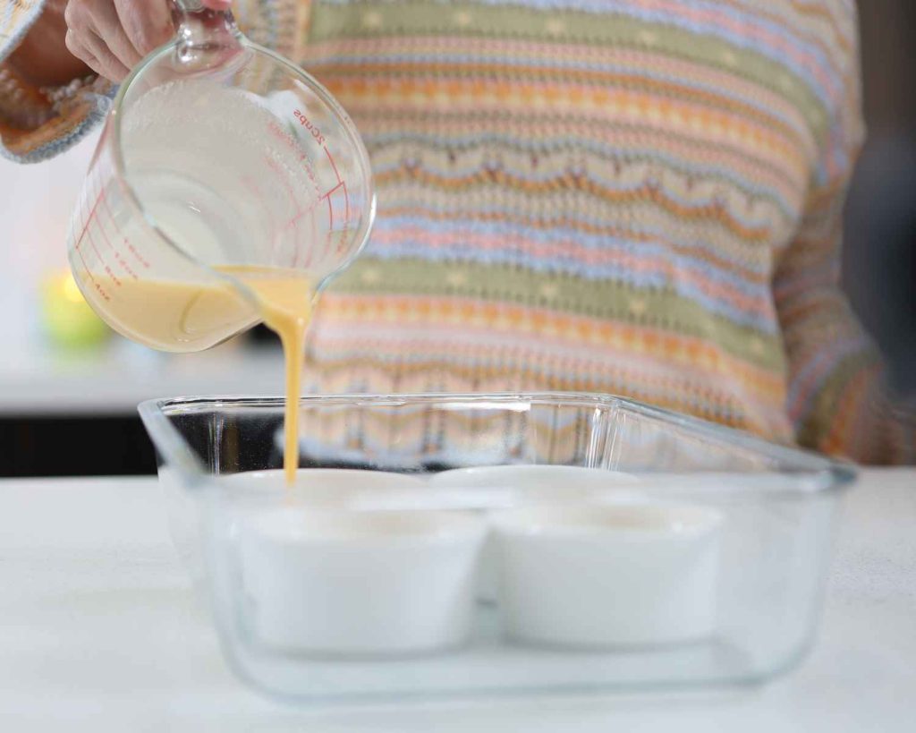 Adding egg mixture into the ramekins