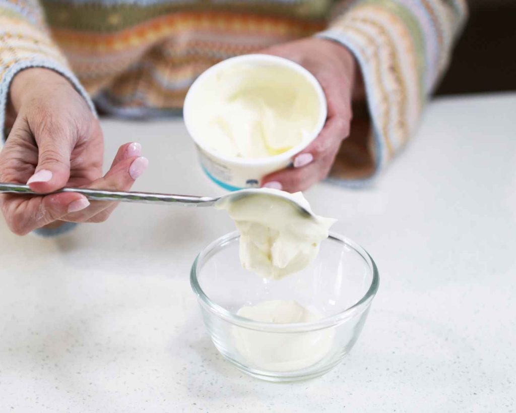 Adding the creme fraiche to a bowl