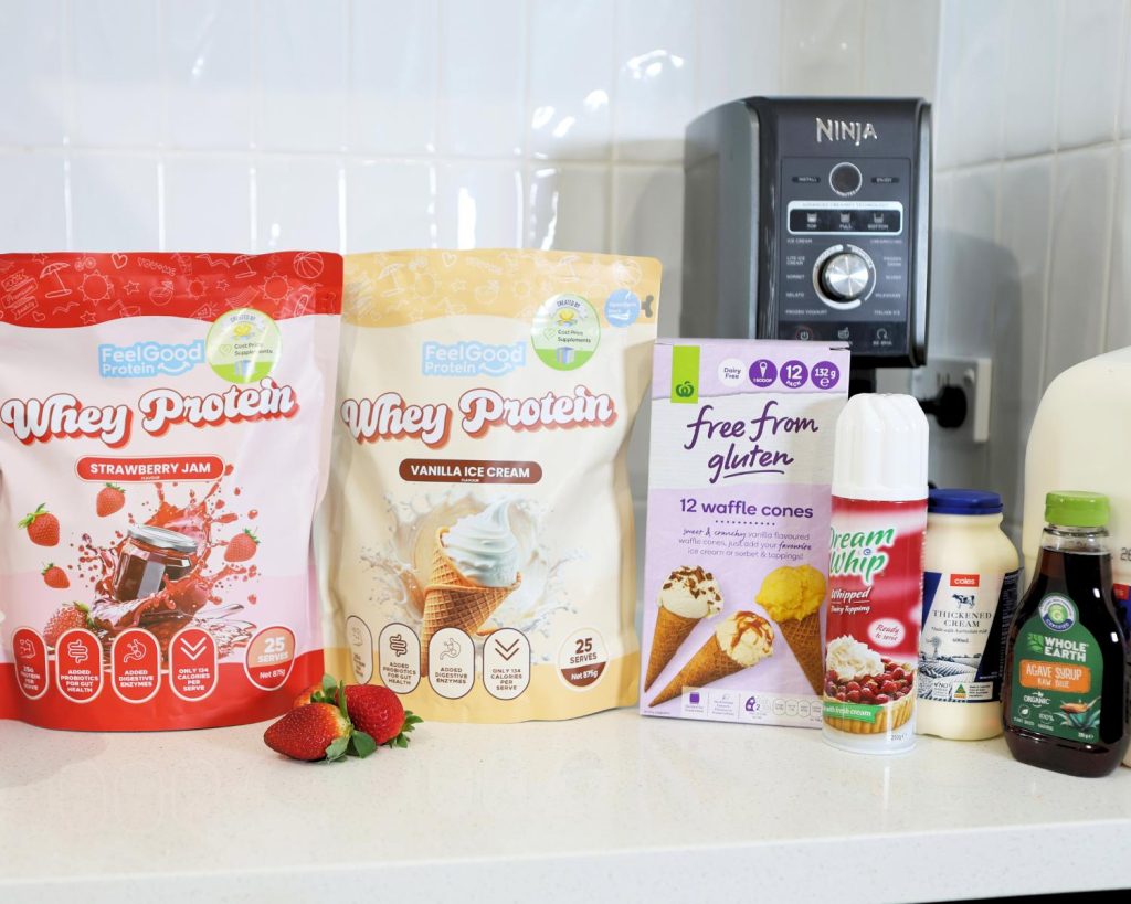Front-facing photo showing all the ingredients for an Ekka Strawberry Sundae recipe side by side on a benchtop, with a softly blurred modern kitchen in the background. 